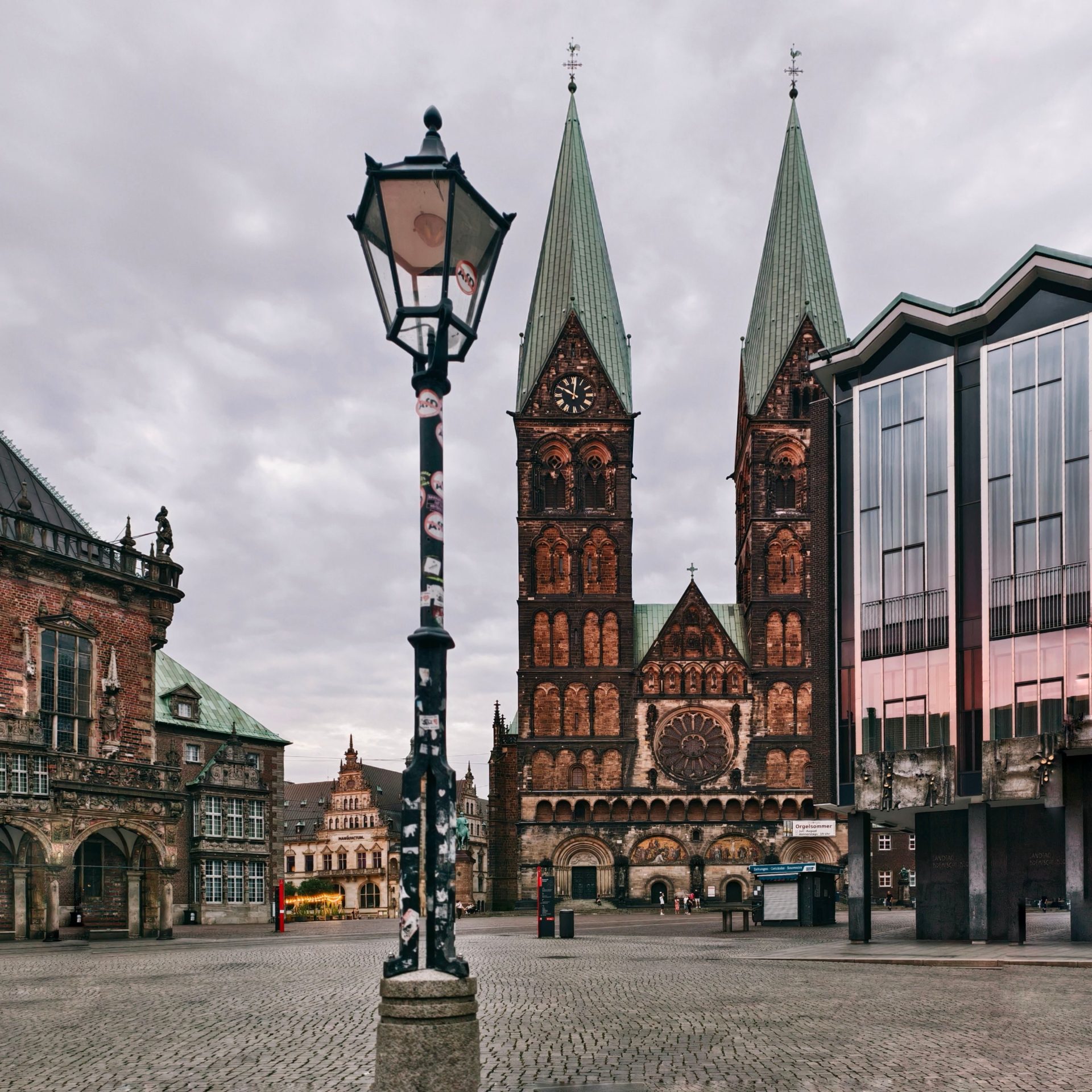View of Bremen Cathedral in Marktplatz Square, showcasing Gothic architecture on a cloudy day.